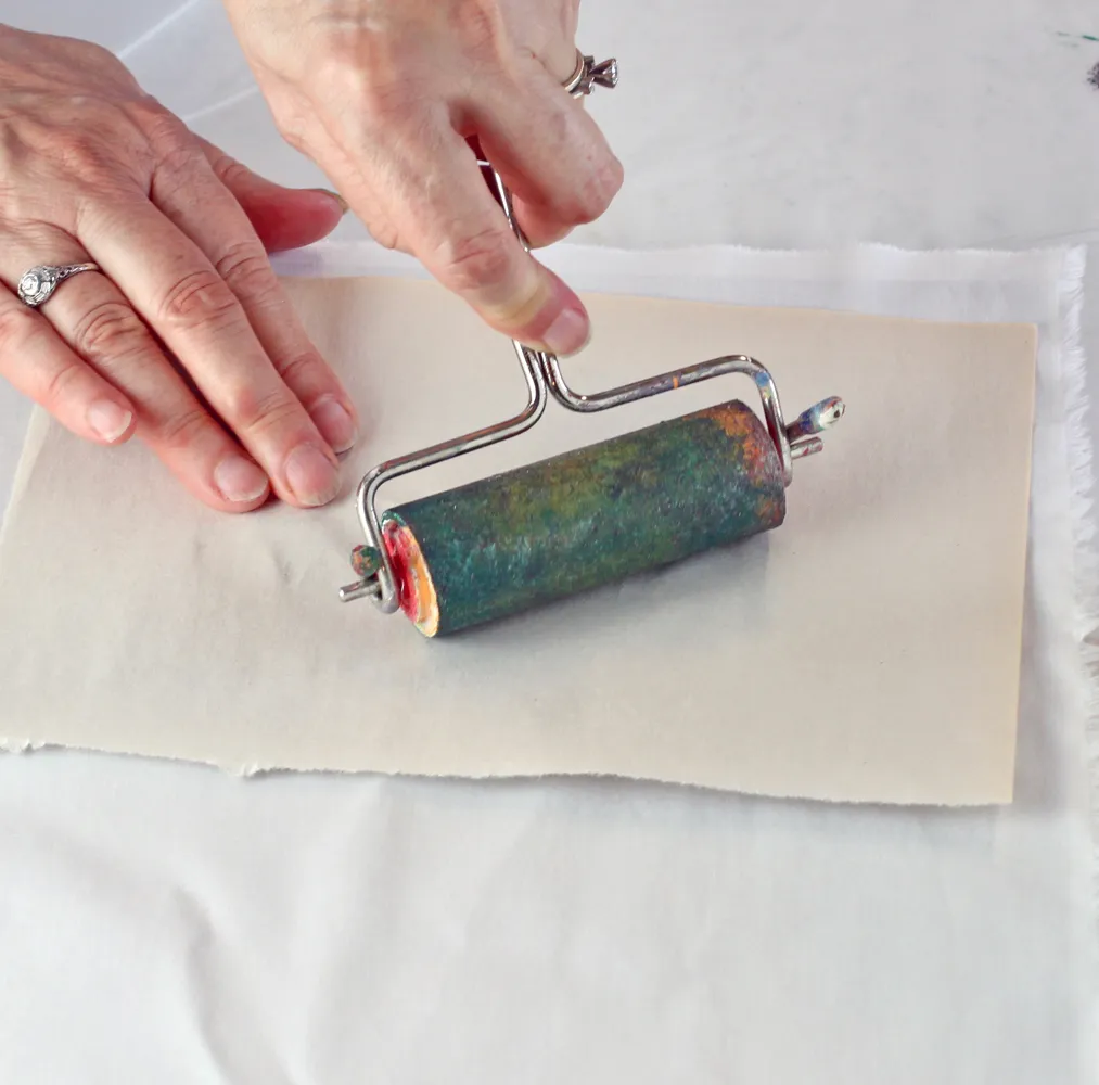 Roll the brayer over the leaf to transfer the print to the fabric